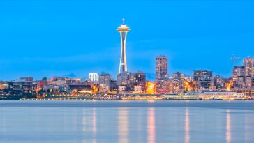 A photo of the Seattle skyline from the water at dusk.