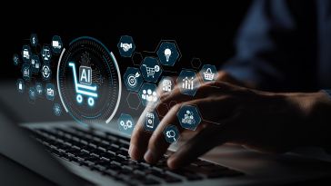Hands typing on a keyboard with digital icons floating above, including a shopping cart labeled “AI.” Represents technology and e-commerce integration.