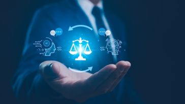 A person in a suit displays a blue hologram in their hand, showing the scales of justice and an arrow between two heads.
