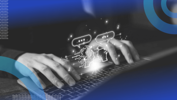 A closeup on a pair of hands on a laptop with two animated heads talking
