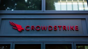 The red CrowdStrike logo on the front of a black building.