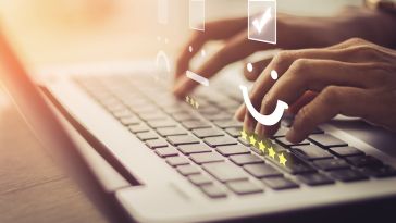 Hands typing on keys with review above