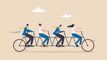 An illustration of four professionals pedaling on a multi-seated bicycle, symbolizing the idea of teamwork
