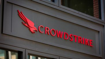 Red "CrowdStrike" logo and falcon emblem on a dark building facade. Modern design, conveys cybersecurity focus, with an assertive, professional tone.