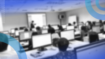 A group of people take a training class on computers
