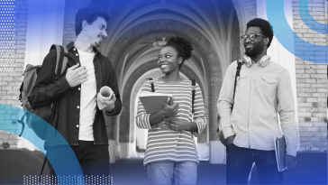A group of students talk on a campus