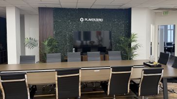 A long conference room table surrounded by chairs.