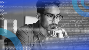 A software developer looks thoughtfully at a computer screen with an overlay of code