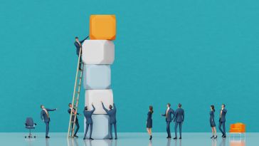 An image of miniature figures adding blocks to a stack and a ladder to show the idea of climbing the career ladder at work.