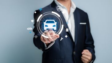 A person in a business suit points toward a glowing digital interface featuring a car icon and the word "INSURANCE," surrounded by smaller floating icons representing vehicle protection and services.