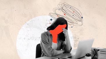 A person working on their laptop with a red face, as if they are experiencing frustration