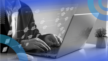 A worker uses a laptop with a database overlay