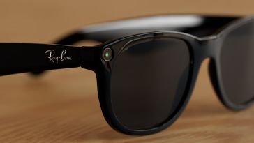A pair of Meta Ray-Ban smart glasses rest on a wooden surface.