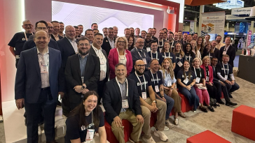 Imprivata team members pose for a large photo during an industry conference