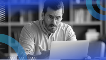A man looks extremely frustrated while using a tablet computer