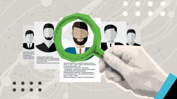 A recruiter uses a magnifying glass to examine an applicant's online profile.