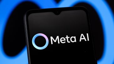 The Meta AI app logo displayed on a mobile phone, with the Meta logo in the background.