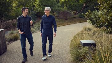 Apple CEO Tim Cook, right, walks with incoming CEO John Ternus at Apple Park. 