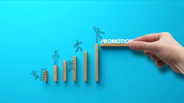 An image of drawn figures climbing on wooden cubes to show the idea of a path to promotion. 