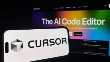 The Cursor logo is shown on a smartphone in front of a laptop.