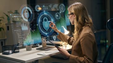 A woman working on a computer with cybersecurity symbols overlaid