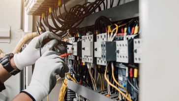 Hands working on an electrical box