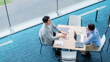 two people at meeting table pictured
