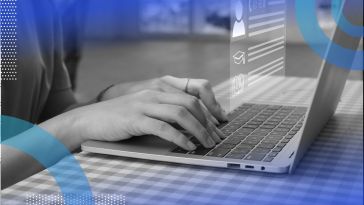 Hands typing on a laptop