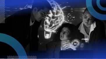 A group of people work around a laptop in front of an image of a brain