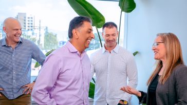 CEO Apu Mody laughs while chatting with Vice President of Technology Hayley Hicks, Vice President of Retail Dan Markenson and Chief Financial Officer John Meloun