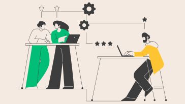 An illustration of two colleagues working on a project together while another colleague types on their laptop beside them