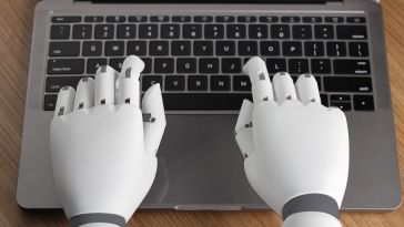 robotic hands type on keyboard