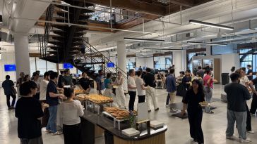 Office building full of people shown.