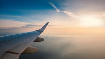 A view of a plane in mid flight wing taken from take from inside the aircraft.