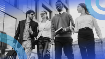 A group of four young professionals walk together