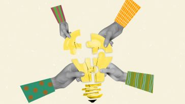 An image of four hands putting together puzzle pieces that create a lightbulb to show the idea of a team working together to create a shared idea or mission. 