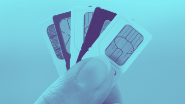 thumb and index finger holding stack of SIM cards