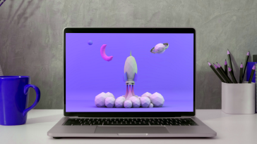 Laptop showing a cartoon rocket ship on the screen, growth hacker