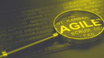 Magnifying glass rests on the word "agile."