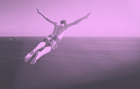 A purple-toned image of a man diving into the ocean. hybrid-creative-business-model