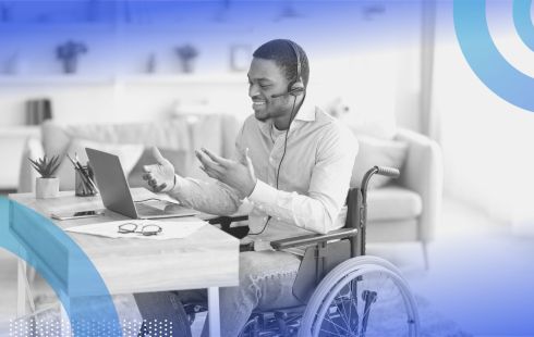 A man in a wheelchair working from home. Remote work helps companies with DEI efforts.