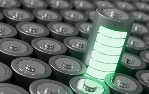 A battery contains glowing green energy bars to represent energy storage.