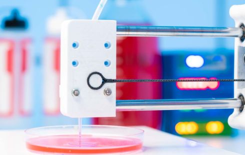 Machine bioprinting a layer of material in a petri dish