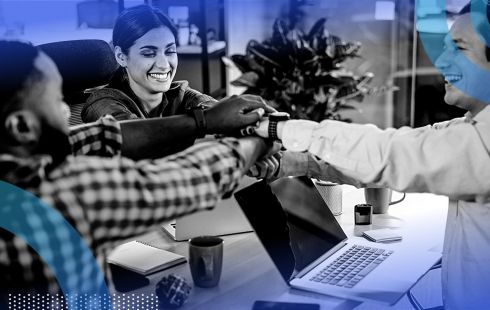 Tech employees engaging in a team-building ritual at work.