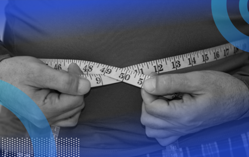 Two hands are holding a measuring tape encircling a person's torso.