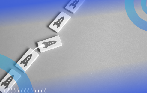 Five domino-shaped rectangles lined up with rocketships printed on them. The middle rocketship rectangle is taking off toward the right, out of the line.