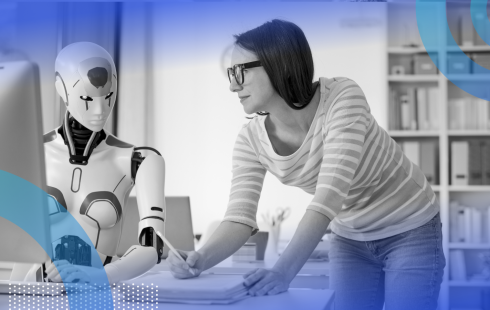 A woman and a robot work together on a computer