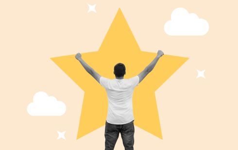 A man holds his hands up in the air with a big yellow star above him.