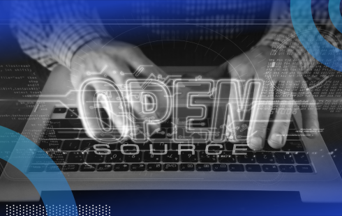 An engineer types on a computer with the words "open source" overlaid