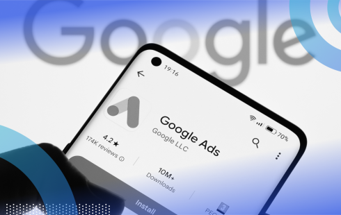 A smartphone with the Google Ads logo in front of the Google logo